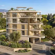 Résidence de quatre niveaux avec architecture contemporaine et végétation environnante.