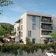 Architecture épurée avec jardins privatifs et végétalisation autour des bâtiments.