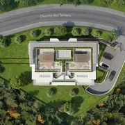 Vue aérienne montrant l'ensemble du bâtiment, les stationnements et les jardins verdoyants entourant la résidence.
